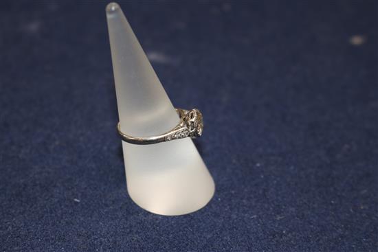 A diamond solitaire ring, the old-cut diamond approx 1.0ct, with diamond-set shoulders on white gold shank, size O.